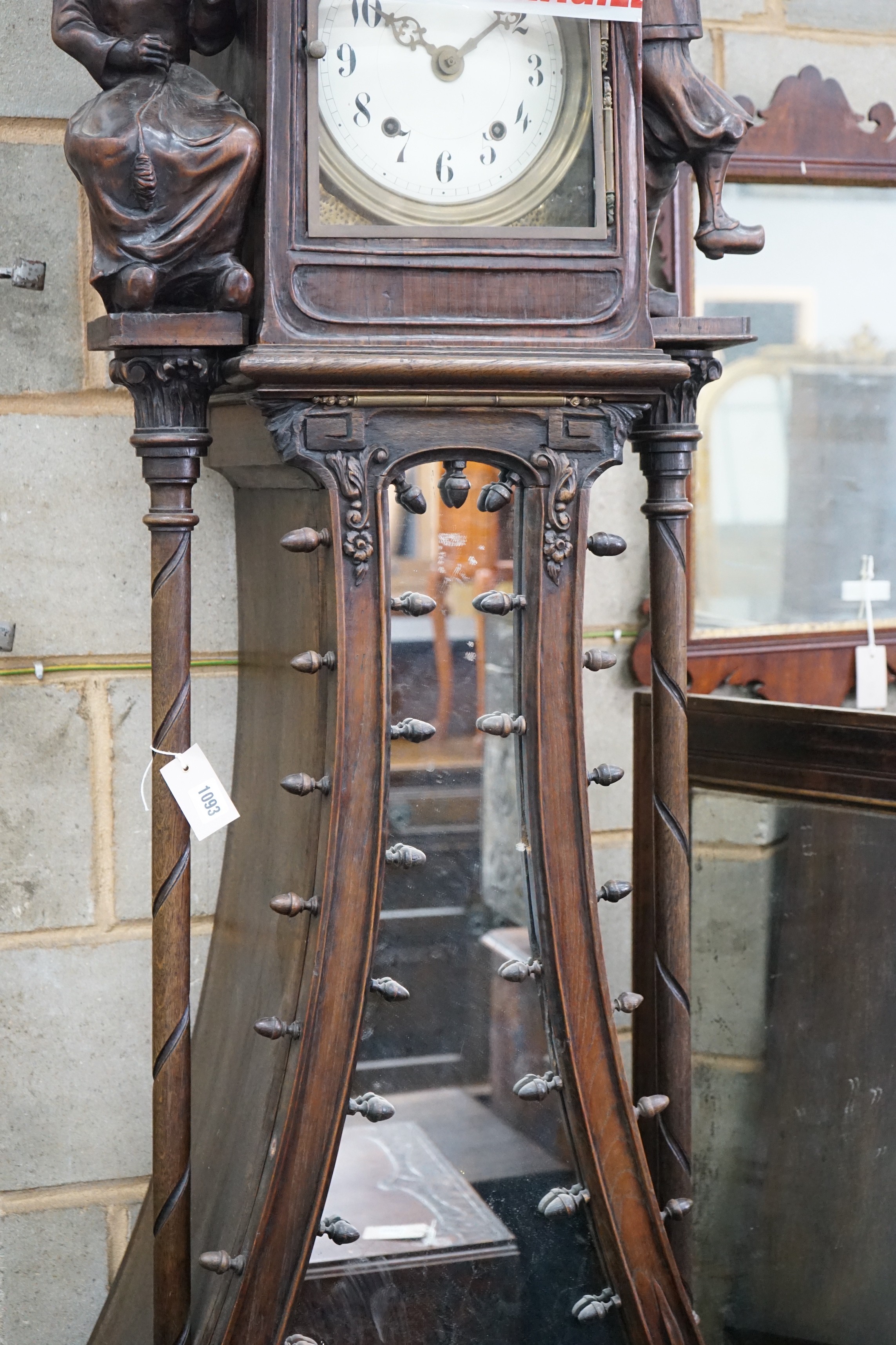 An early 20th century Flemish carved oak and walnut longcase clock, height 240cms.